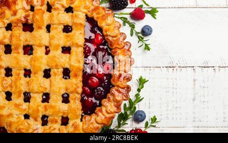 Homemade summer berry pie on rustic wooden background with copy space. Top view. Stock Photo