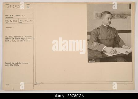 Lt. Col. Richard B. Paddock, from the office of the Chief Signal Officer in Washington, D.C., is seen sitting at his desk in this photo taken on February 25, 1919. The photograph was received on March 3, 1919, and was approved by the M.I.D. censor on March 10, 1919. It was issued at PEay, Pa with the notes regarding the image labeled as 39182. Stock Photo