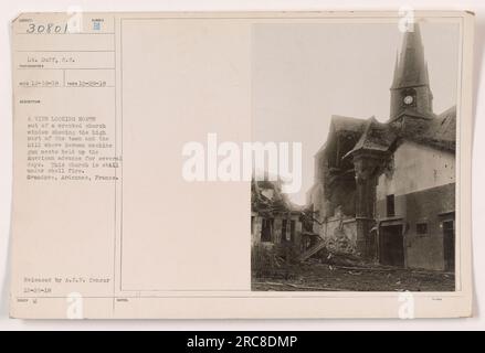 Factual caption: View looking north out of a wrecked church window in Grandpre, Ardennes, France during World War I. The photograph shows the high part of the town and the hill where German machine gun nests caused a delay in the American advance. The church is still being bombarded. Stock Photo