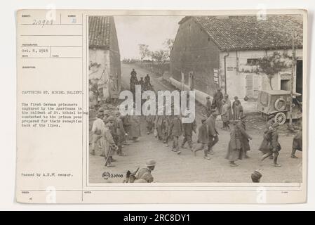 American soldiers escorting German prisoners of war to the prison pens behind the lines after capturing the St. Mihiel salient during World War I. Image depicts the scene from October 5, 1918. This photograph was taken by an official military photographer and passed by the Allied Expeditionary Censor. Stock Photo