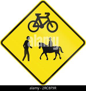 An Australian warning traffic sign - Crossing for pedestrians, cyclistst and equestrians ahead Stock Photo