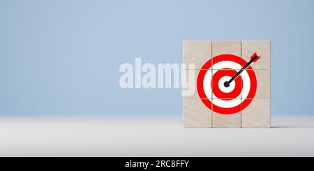 Business goal and success concept. Focus on goal and achieve successful business. Wooden blocks with target icon on wooden table blue background copy Stock Photo