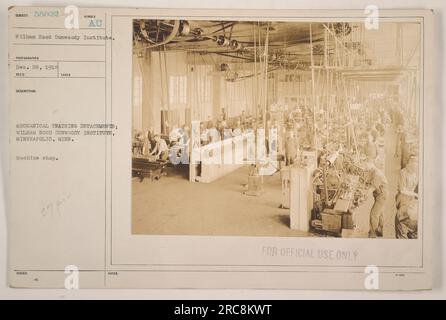 A group of soldiers are seen working at the machine shop in the Wilham Hood Dunwoody Institute, Minneapolis, Minnesota during World War One. This image shows members of the Mechanical Training Detachments receiving practical instruction and learning mechanical skills for military purposes. Stock Photo