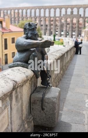 Devil statue Segovia, view of the Estatua del Diablo, a bronze statue of a smiling devil taking a selfie photo of itself sited in the city of Segovia. Stock Photo