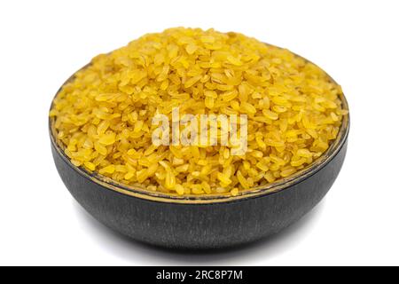 Raw bulgur wheat  isolated on white background. Uncooked dried bulgur in bowl Stock Photo