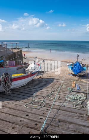 Small fishing boats moored up on the concrete and wooden ramp at Sheringham, Norfolk, England, U.K. Stock Photo