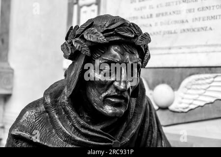 Florence, Italy - April 5, 2022: Bronze sculpture of Dante Alighieri, the legendary Italian poet in the courtyard of Badia Fiorentina, Florence, Italy Stock Photo