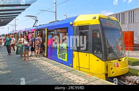 Yellow Manchester Metrolink Ashton tram, at Castlefield Deansgate, city centre, England, UK, M3 4LG Stock Photo