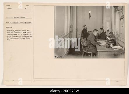 'Photograph of Room C-3, Stenographic Reporting Office of the Peace Commission in Paris, France. The image shows Field Clerk C.A. Leedy, along with Privates B.S. Dicks and H.P. Anderson on February 3, 1929. The photo was taken by the Signal Corps. Notes indicate the assigned number for this image is 62950.' Stock Photo