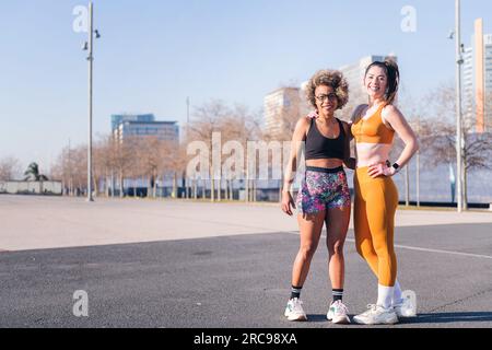 two multiethnic sportive friends looking at camera Stock Photo