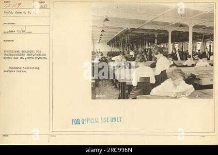 Vocational training for women at the Machine Shop of Packard Motor Car Co. in Detroit, Michigan during World War One. In the image, students can be seen inspecting various parts. This photograph is part of the official records. Stock Photo