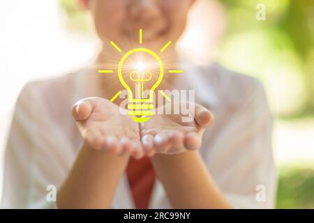 happy people with lightbulb icon bright in hand support for creativity life ignition for saving energy eco power for environmental activity concept Stock Photo