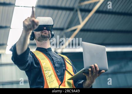 Engineer male using VR virtual reality technology in modern warehouse factory new innovation engineering Stock Photo