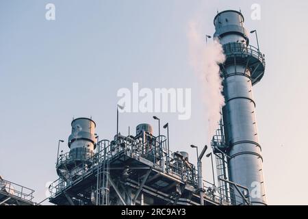Power station clean modern factory Petroleum petrochemical industry building outdoors landscape with large chimney releasing smoke. Stock Photo