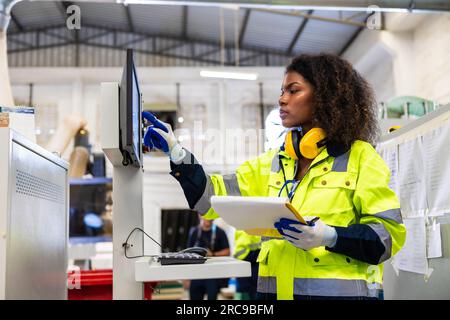 staff woman worker work operate cutting machine. Lathe CNC engineer. modern factory working woman. smart women worker industry workplace Stock Photo