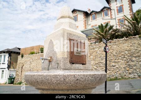 A public fountain with drinking water in Ventnor on the Isle of Wight, England, on a summer day. Stock Photo