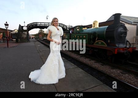 A Page & Picture wedding shoot at the Bluebell Railway, East Sussex, photographed by Sam Stephenson, with model in a Fross Wedding Collections dress. Stock Photo