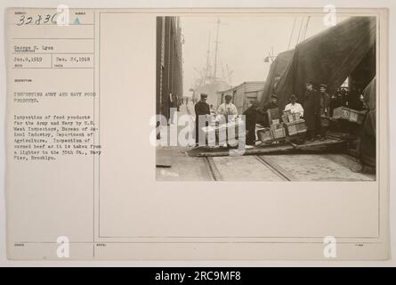 US meat inspectors from the Bureau of Animal Industry, Department of Agriculture, inspecting corned beef for the Army and Navy. The inspection is taking place as the corned beef is being transferred from a lighter to the Navy Pier in Brooklyn. Photograph taken by George H. Lyon on January 8, 1919. Stock Photo