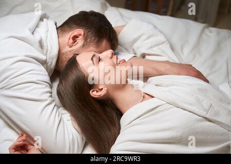 Romantic couple resting together in hotel room Stock Photo