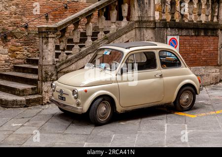 Siena, Italy - APR 7, 2022: Vintage buggy car parked in a street in Siena, Tuscany, Italy. Stock Photo