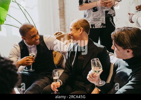 Happy business colleagues enjoying together while having drinks during event at convention center Stock Photo