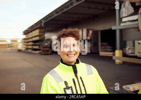 Portrait of cheerful mature female worker at industry Stock Photo