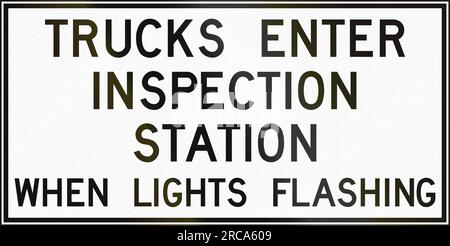 Regulatory sign in Canada - Trucks enter inspection station when lights flashing. This sign is used in Ontario. Stock Photo