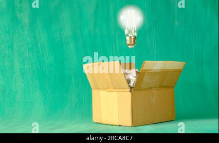 thinking outside the box,Innovation,idea,vision, business concept, grungy box with crumpled paper and light bulb, symbolic and meataphoric Stock Photo