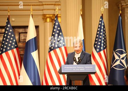 13 July 2023, Finland, Helsinki: Finnish President Sauli Niinistö speaks at a press conference with U.S. President Biden (not pictured) at the Presidential Palace in Helsinki. In the background there is a NATO flag next to American and Finnish flags. (to dpa Harmony in Helsinki - Biden and Northerners emphasize unity) Photo: Steffen Trumpf/dpa Stock Photo