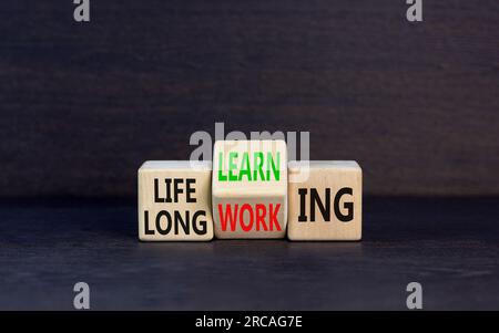 Lifelong learning working symbol. Concept word Lifelong learning working on block on a beautiful grey table grey background. Business educational life Stock Photo