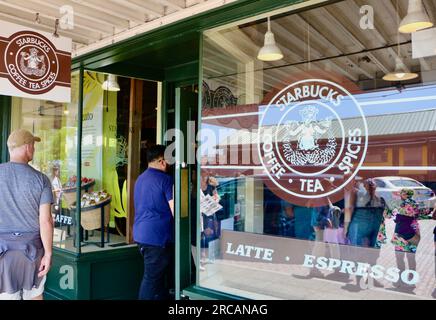 People standing in line at the Pike Place Starbucks first Starbucks store entrance Seattle Washington State USA Stock Photo