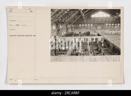 Interior view of military barracks - This photograph, taken in 1919, shows the inside of a military barracks. The image captures rows of neatly arranged bunk beds and lockers, highlighting the lack of personal space afforded to soldiers during World War I. Stock Photo