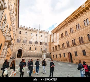 Siena, Italy - APR 7, 2022: The Piazza Salimbeni is a prominent square in central Siena, Region of Tuscany, Italy. The square hosts multiple landmarks Stock Photo