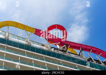 Ensenada, BC, Mexico – June 4, 2023: Royal Caribbean’s Navigator of the Seas cruise ship with view of water slide and balconies on the port side. Stock Photo