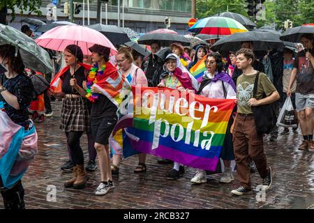 Queerpolia. Metropolia University of Applied Sciences students holding a banner at Helsinki Pride 2023 parade in Helsinki, Finland. Stock Photo