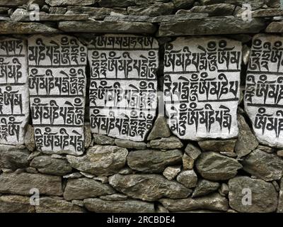 Mani wall, buddhist mantra carved in stones Stock Photo