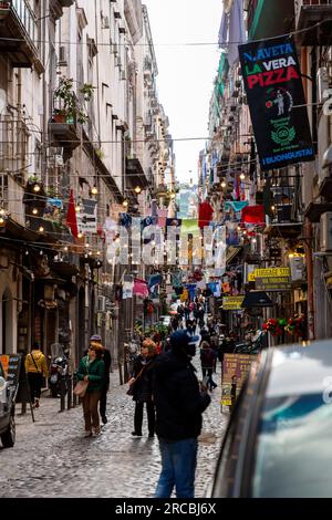 Naples, Italy - April 10, 2022: Via dei Tribunali is a busy and touristic street in the old historic center of Naples, Campania, Italy. Stock Photo