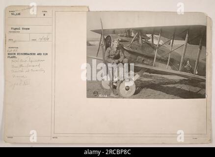 'Eddie Rickenbacker, a prominent World War I pilot, pictured with his plane, a Spad XIII, near Rembercourt, Meurthe et Moselle, France. The photograph was taken by the Signal Corps photographer BECO and is labeled as #29655 188UED. Rickenbacker was a member of the 94th Aero Squadron. Spad XIII was a popular aircraft used in the war.' Stock Photo