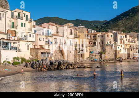 The beach and Old Town in Cefalù on a sunny evening in July 2023. Historic Cefalù is a major travel destination on Sicily. Stock Photo