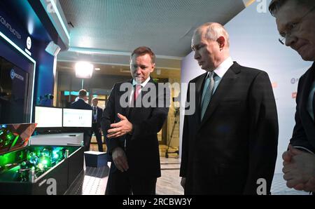 Moscow, Russia. 13th July, 2023. Russian President Vladimir Putin, right, listens to a Russian Quantum Center Co-founder Ruslan Yunusov, left, explain advanced research and development projects in quantum technologies during the Future Technologies Forum at the World Trade Center, July 13, 2023 in Moscow, Russia. Credit: Alexander Kazakov/Kremlin Pool/Alamy Live News Stock Photo