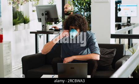Startup manager making presentation on laptop in business coworking space. Middle eastern entrepreneur checking data statistics to create financial report and solve new task. Tripod shot. Stock Photo