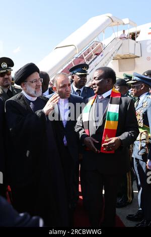 Harare, Harare, Zimbabwe. 13th July, 2023. Zimbabwe President EMMERSON MNANGAGWA greets Iranian President EBRAHIM RAISI as he arrives at Harare. (Credit Image: © Iranian Presidency via ZUMA Press Wire) EDITORIAL USAGE ONLY! Not for Commercial USAGE! Stock Photo