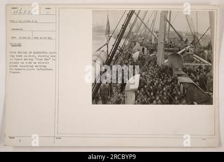 Men aboard the Manchuria waving goodbye to people on the dock as the ship departs from St. Nazaire, France. The photograph, taken by PVT.J.M.LILES.S.C., shows the view from the bridge looking down on the deck. The whistle blowing serves as a departure warning. The image was captured on January 10, 1919. Stock Photo