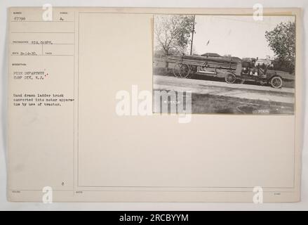 'Hand drawn ladder truck converted into a motor apparatus by attaching a tractor at the Fire Department in Camp Dix, New Jersey. This photograph, taken on February 14, 1920, shows the transformation of the truck. Image from a collection of American military activities during World War One.' Stock Photo