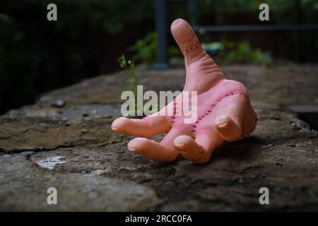 Realistic human hand or Thing with scars and stiches. Wednesday Addams movie concept. Stock Photo