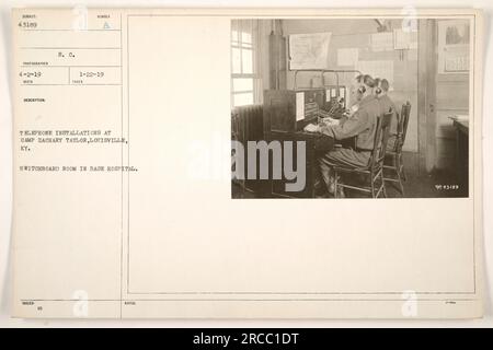 Switchboard room in the base hospital at Camp Zachary Taylor, Louisville, KY during World War One. This image shows telephone installations and an operator handling calls. Stock Photo