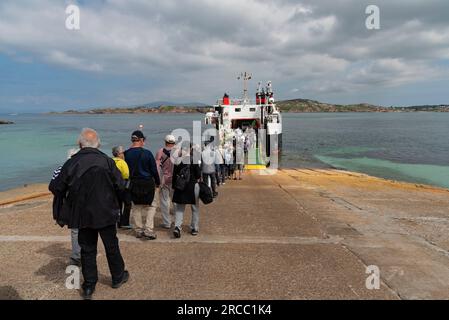 Isle of Iona, Scotland, UK.  6 June 2023.  Foot passengers departing the Isle of Iona to a inter island ferry Loch Buie to Fionnphort, Isle of Mull. Stock Photo