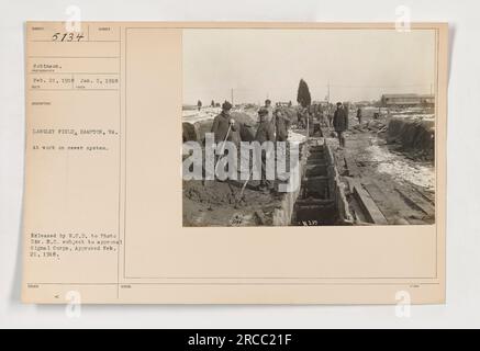 A soldier at Langley Field, Hampton, VA, is seen working on a sewer system on January 5, 1918. The image, numbered 5134 and taken by Robinson, was approved by the Signal Corps on February 21, 1918. It was released by W.C.D. to Photo Div. 9.C., subject to approval. Stock Photo
