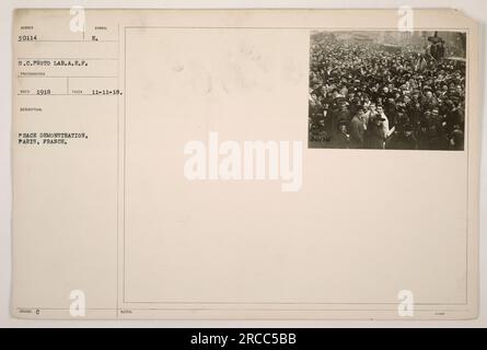 Image shows a peace demonstration in Paris, France during World War One. The photograph was taken on November 11, 1918, depicting people gathering in support of peace. The source of the photograph is the S.C. Photo Lab of the A.E.P., and it carries the label number 30114. Stock Photo