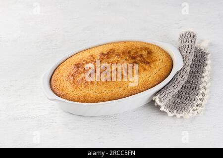 Freshly prepared mannik, semolina pie in the form on light gray background. Stock Photo